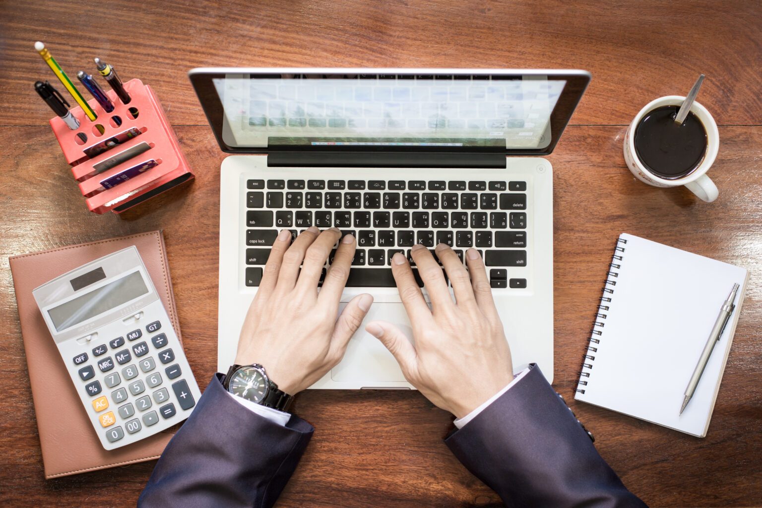 Top view of business man hands working on laptop or tablet pc on